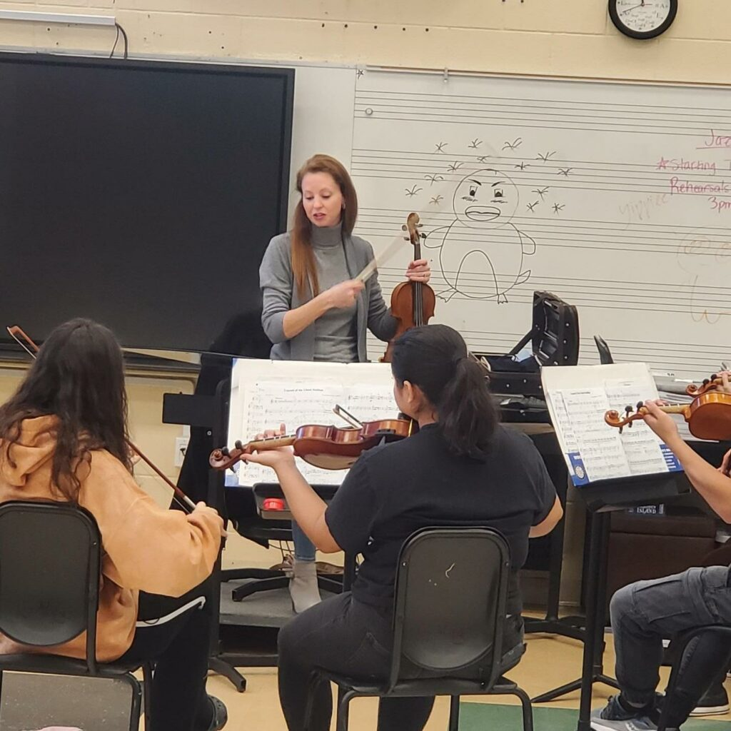 FSO Concertmaster Robyn Bauer works with city orchestra students